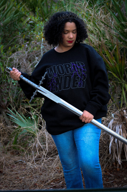 Person wearing a black sweatshirt with 'World Ender' text, holding a sword in an outdoor setting.
