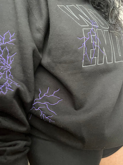 Black sweatshirt with white words and purple lightning on the back