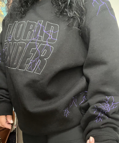 Person wearing a black sweatshirt with 'World Ender' text and lightning designs.